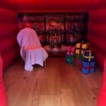 A Santas grotto themed inflatable house looking inside.