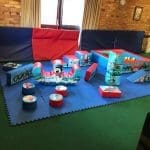 Christmas themed soft play set with festive ball pit and 19 soft play shapes, set on click-lock matting – available for hire in Essex.