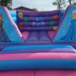 an 8ft Frozen themed castle in pink and purple