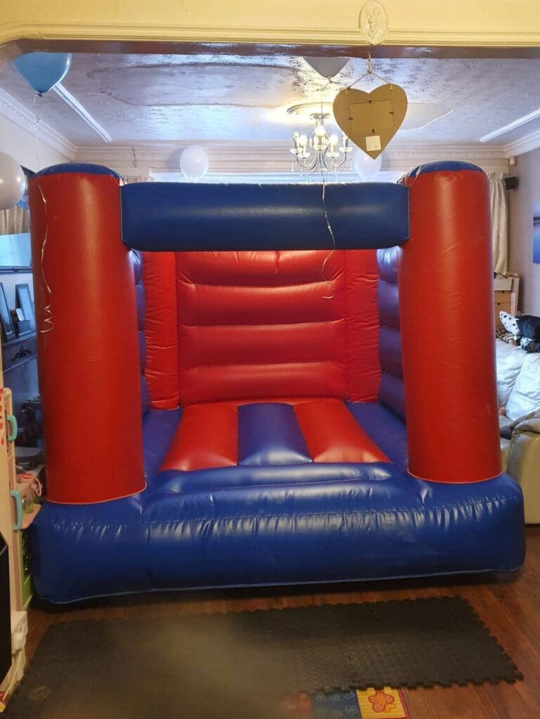 a red and blue cpompact bouncy castle