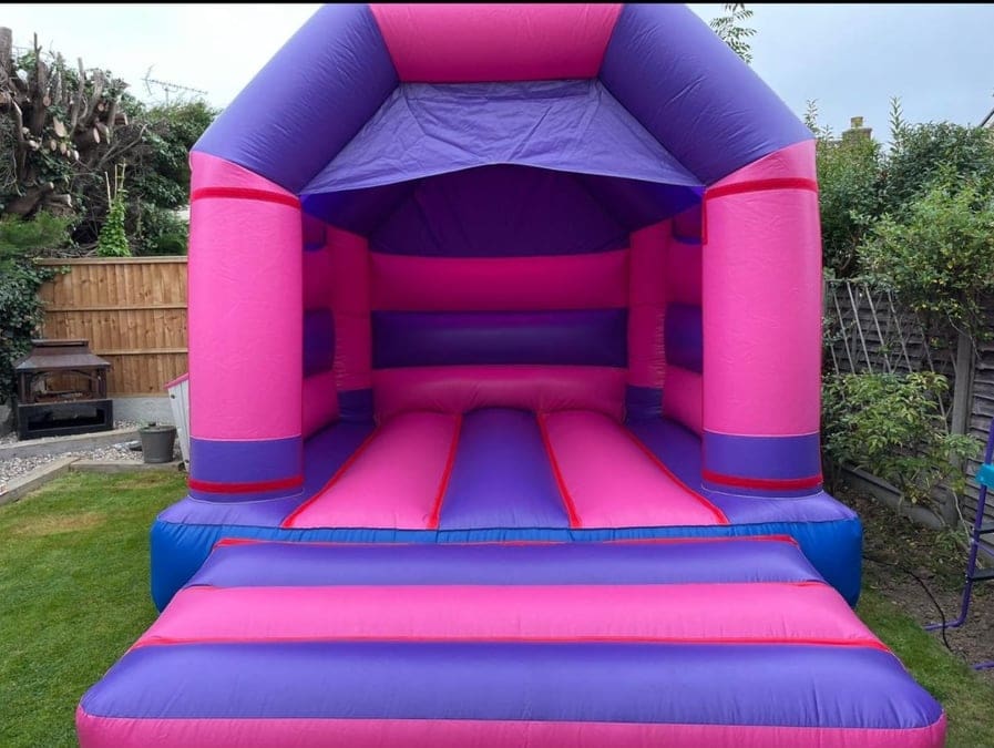 a bouncy castle decorated in pink and purple