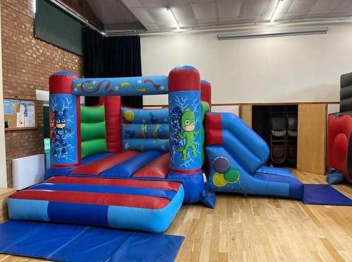 A PJ Masks themed velcro style bouncy castle with slide