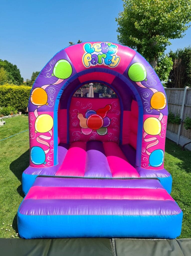 a pink and purple low arch style bouncy castle