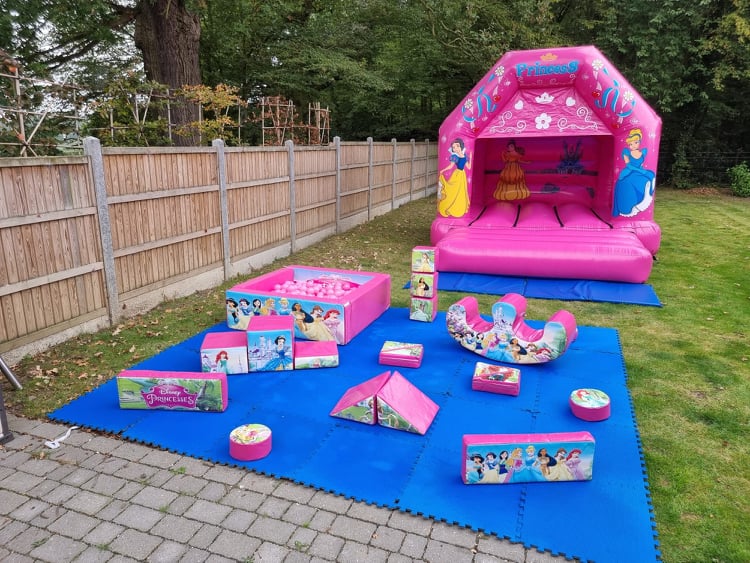 Pink Princess themed bouncy castle and soft play showing what is included in package