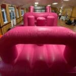 a shiny pink themed obstacle course starting point