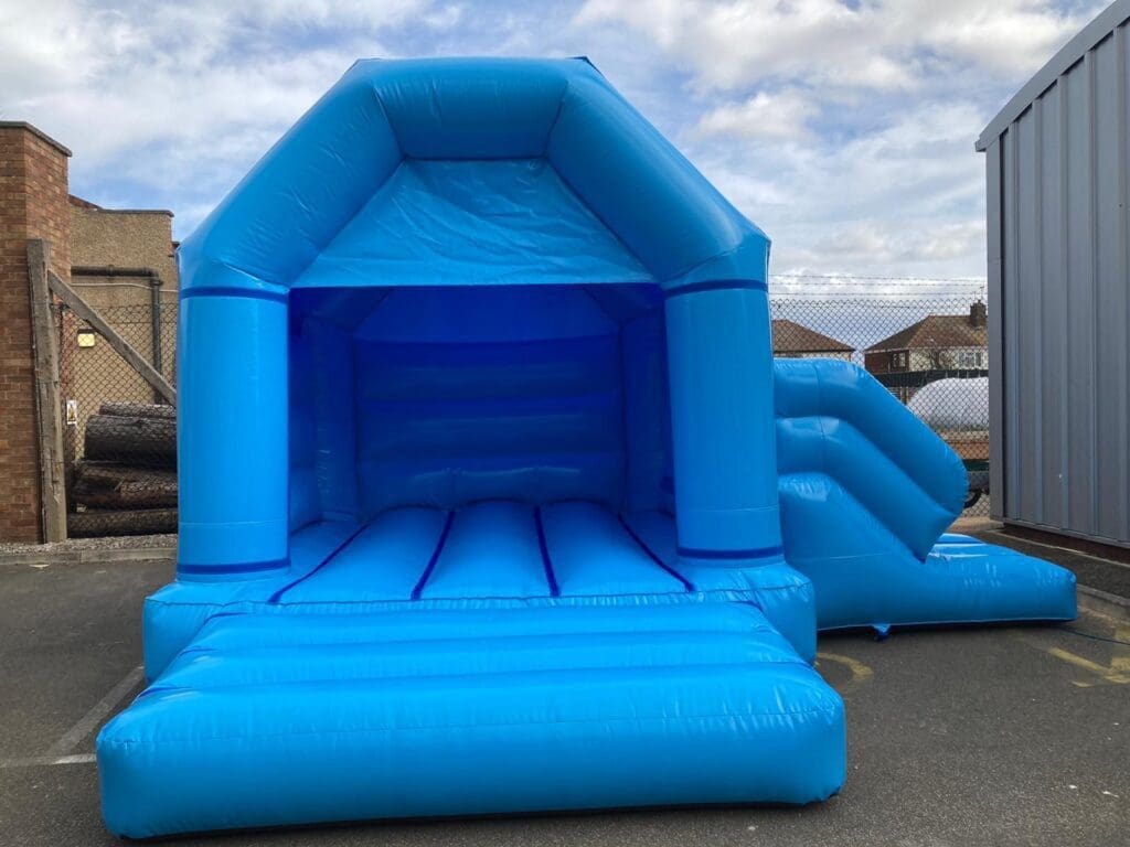 a blue bouncy castle with slide in pastel blue