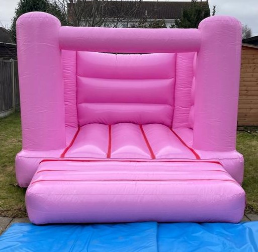 A pink pastel coloured small bouncy castle