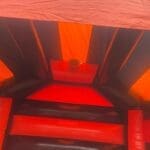 a view from inside an adult sized bouncy castle showing music and lights