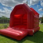 A plain red velcro themed bouncy castle
