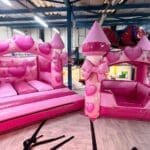 Pink Hearts & Bows bouncy castle and matching ball pool with heart and bow artwork – perfect for princess-themed parties and available for hire in Essex.